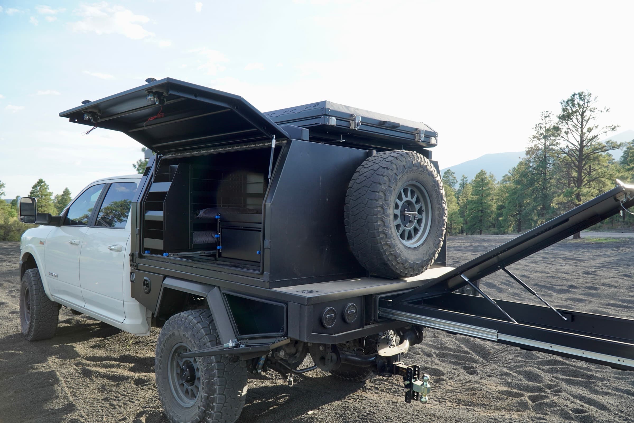 Ram 2500 with touring canopy and deployed rear platform on gas struts