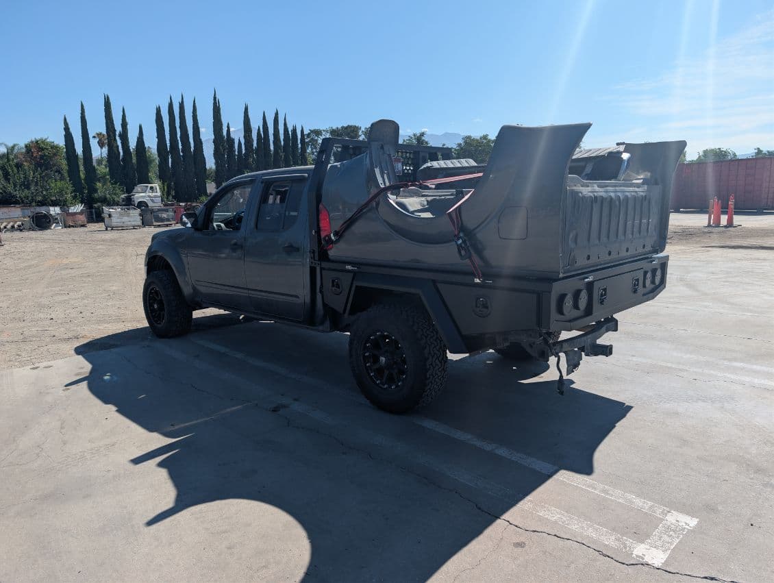 Rear view of the Nissan Frontier aluminum flatbed showing the deck and under-tray boxes
